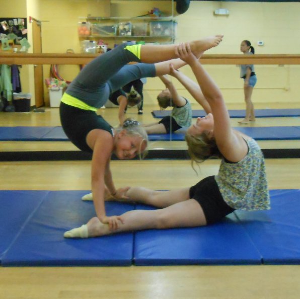 Sophia and Jessie work on stunts in the acrobatics class at AMA