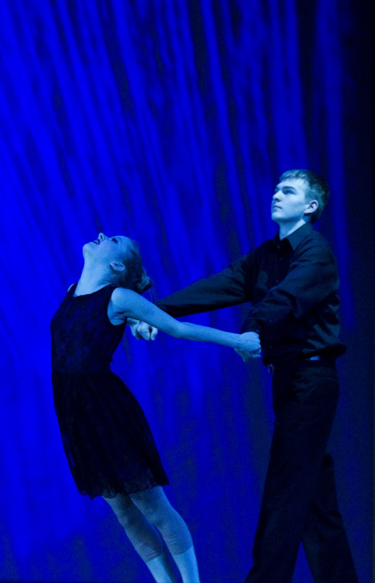 Conrad dancing with a young lady during a performance.