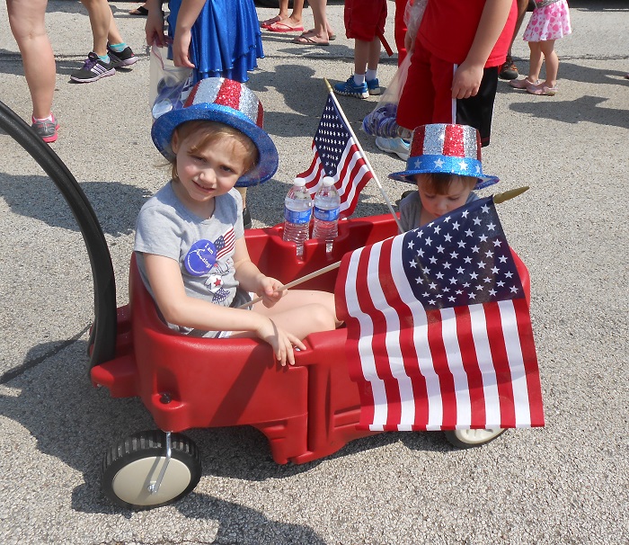 AMA kids waive their flags in the parade