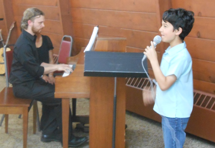 A student sings during an AMA recital
