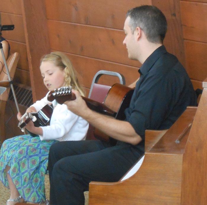 Mr Dan with a student during a music recital