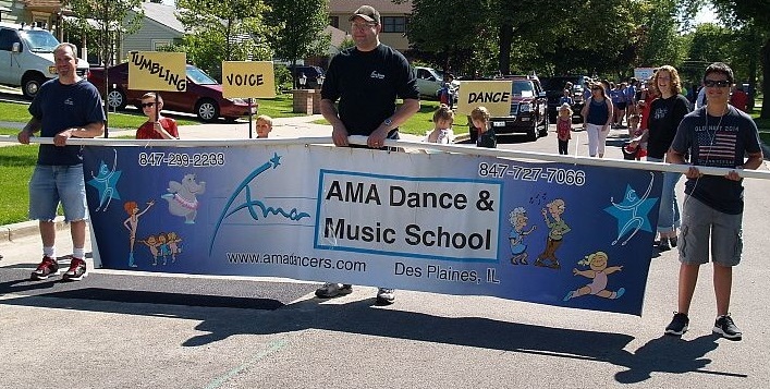Fathers carry AMA Banner in July 4th parade