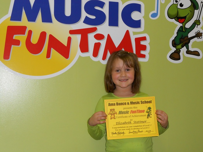 A Music FunTime student holds her certificate