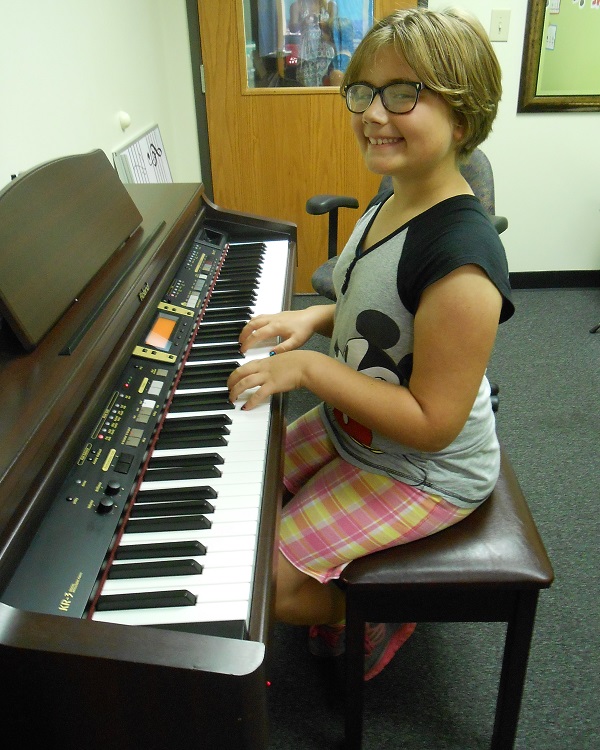 Julia plays piano at AMA
