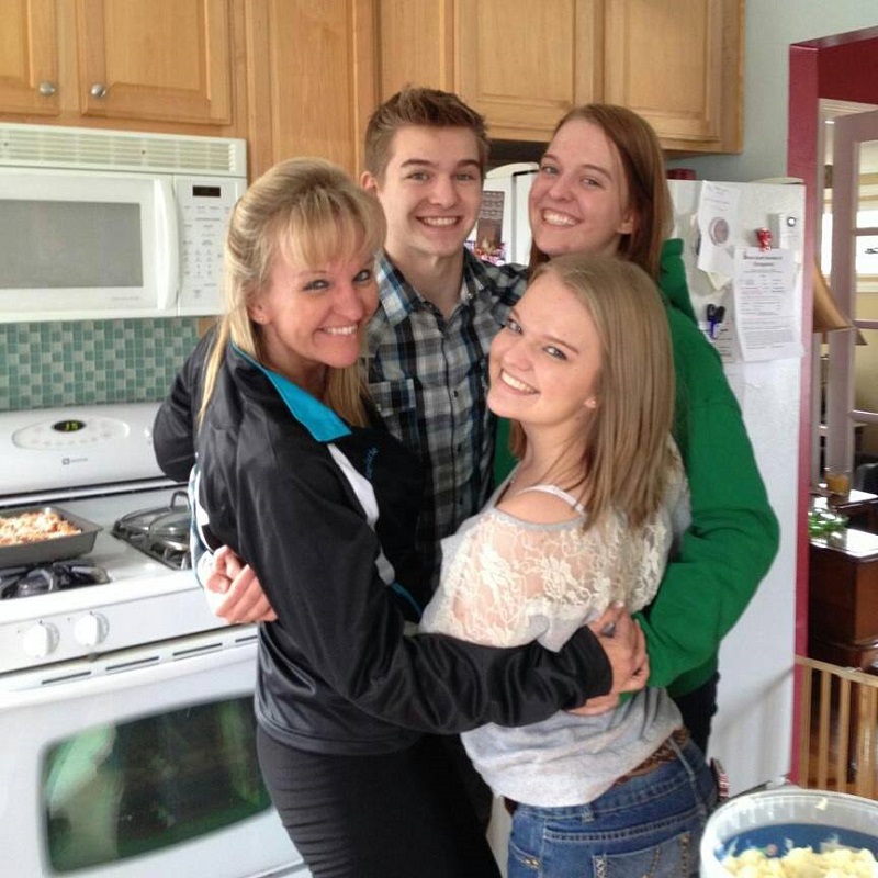 Ann Marie Frank poses in the kitchen with her kids