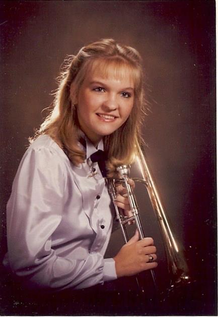 A teenage Ann Marie poses with her trombone