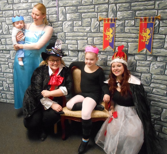 Another student poses with AMA princesses and the Mad Hatter too